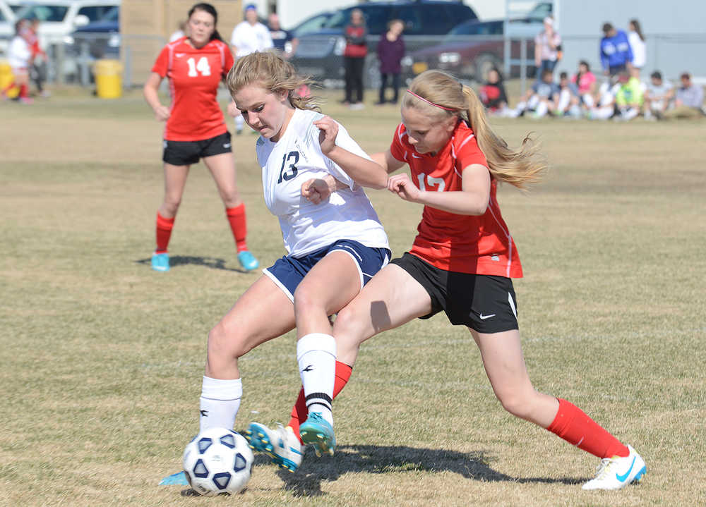 Photo by Rashah McChesney/Peninsula Clarion  Soldotna's Olivia Conradi fights for the ball with Wasilla's Jodi Richie during their game Friday May 9, 2014 in Soldotna, Alaska.