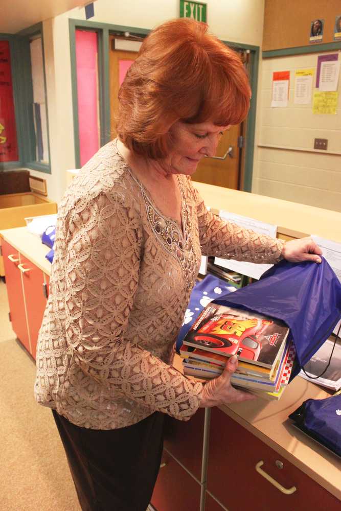 Photo by Kelly Sullivan/Peninsula Clarion Debbie Adamson bought bags of books for each of the winners of this year's Reading Counts program, Friday, May 9, at Soldotna Elementary School.