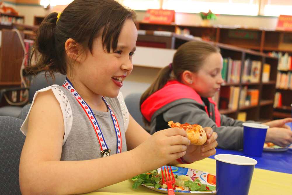 Photo by Kelly Sullivan/ Peninsula Clarion Rilee Erickson and Andi Hiler enjoy the lunch provided for the winners of this year's Reading Counts program, Friday, May 9, at Soldotna Elementary school.