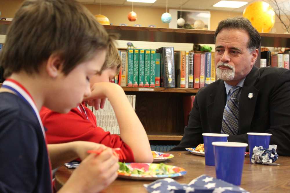 Photo by Kelly Sullivan/ Peninsula Clarion Sen. Peter Micciche sat with the winners during lunch and asked them if they would continue reading over the summer, Friday, May 9, at Soldotna Elementary School.