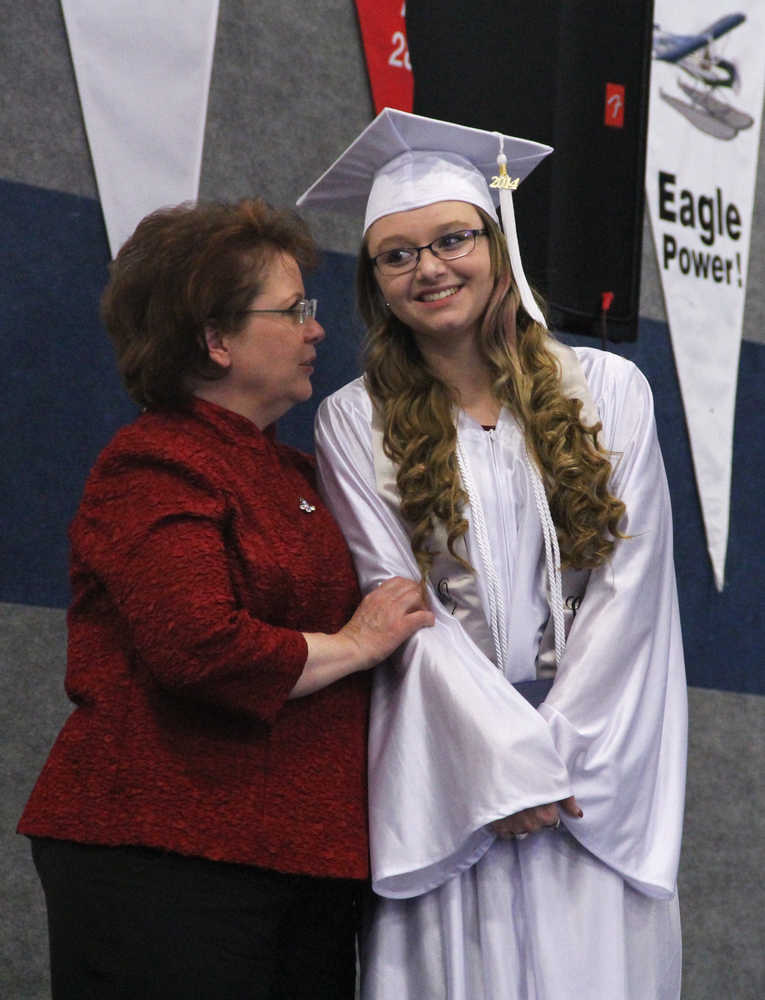 Photo by Dan Balmer/Peninsula Clarion Cook Inlet Academy principal Mary Rowley congratulates Courtney Snodgress after receiving her diploma Sunday. Snodgress plans to attend the University of Alaska Fairbanks and work toward becomming a dental hygienist.