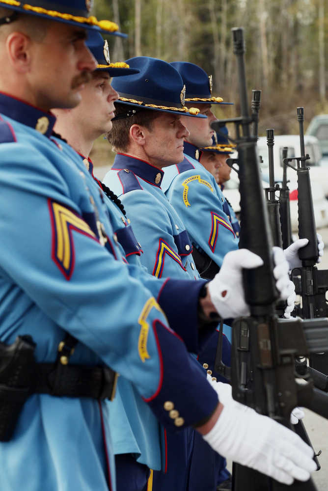 The Alaska State Trooper 21-Gun Salute Firing Party stands at attention during the playing of TAPS during the memorial service for Alaska State Trooper Sgt. Patrick "Scott" Johnson and Trooper Gabriel "Gabe" Rich at the Carlson Center, Saturday, May 10, 2014m in Fairbanks, Alaska. The tow were killed in the line of duty in the village of Tanana earlier this month. (AP Photo/The Fairbanks Daily News-Miner, Eric Engman)