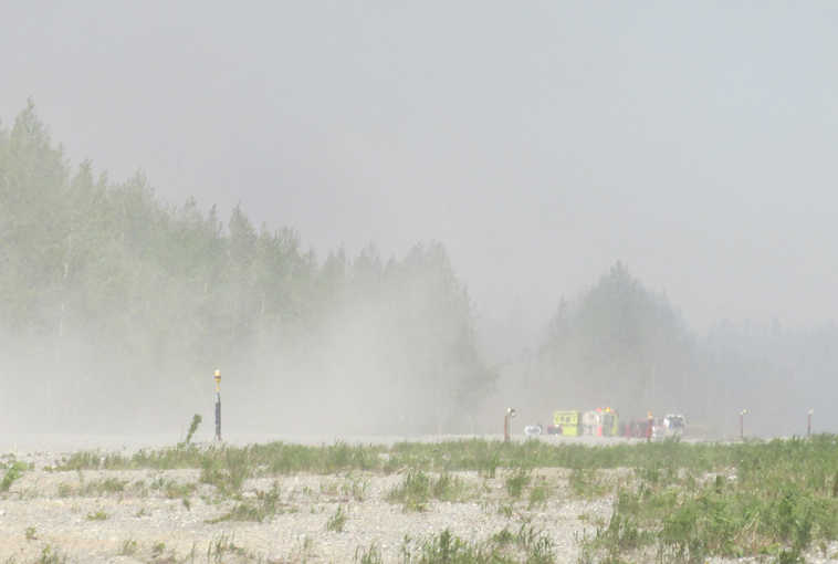 Photo courtesy Pam Howard Emergency crews stage at the end of the runway in Tyonek Monday afternoon. The blaze grew to 80 acres by Monday evening.