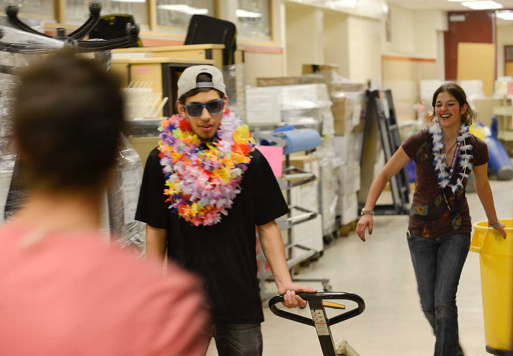 Photo by Rashah McChesney/Peninsula Clarion  Chris Casares and Tralessa Mahan helped to clean and organize classrooms for outgoing Skyview High School teachers on the last day of school Wednesday May 21, 2014 in Soldotna, Alaska.