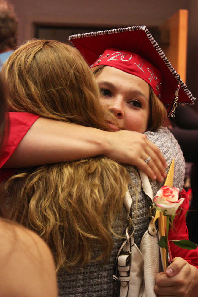 Photo by Kelly Sullivan/Peninsula Clarion Zoya Elder Hanson hugs her friend after the graduation ceremony, Wednesday, May 21, at Kenai Central High School.