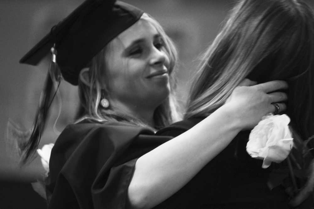 Photo by Kelly Sullivan/ Peninsula Clarion Elizabeth McGlothen chose to give her mother a yellow rose recognizing she helped her get through her high school years, Tuesday, May 22, at the Soldotna Regional Sports Complex.