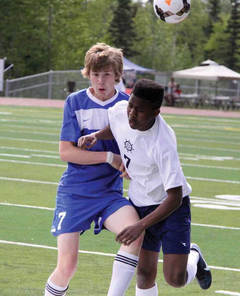 Palmer junior Glenn Woodworth collides with Homer's Max Mangue during a 3-0 loss to the Mariners in the first round of the Northern Lights Conference Championships soccer tournament at Wasilla High School May 22.