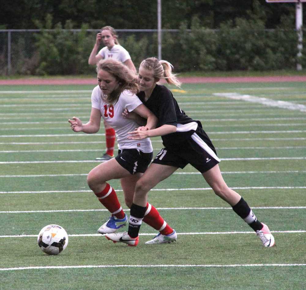 Wasilla sophomore Daija Doughty fights past Nikiski's Molly Cason during a 3-0 win over the Bulldogs. The Warriors moved into the Northern Lights Conference Championships semifinals with the win.