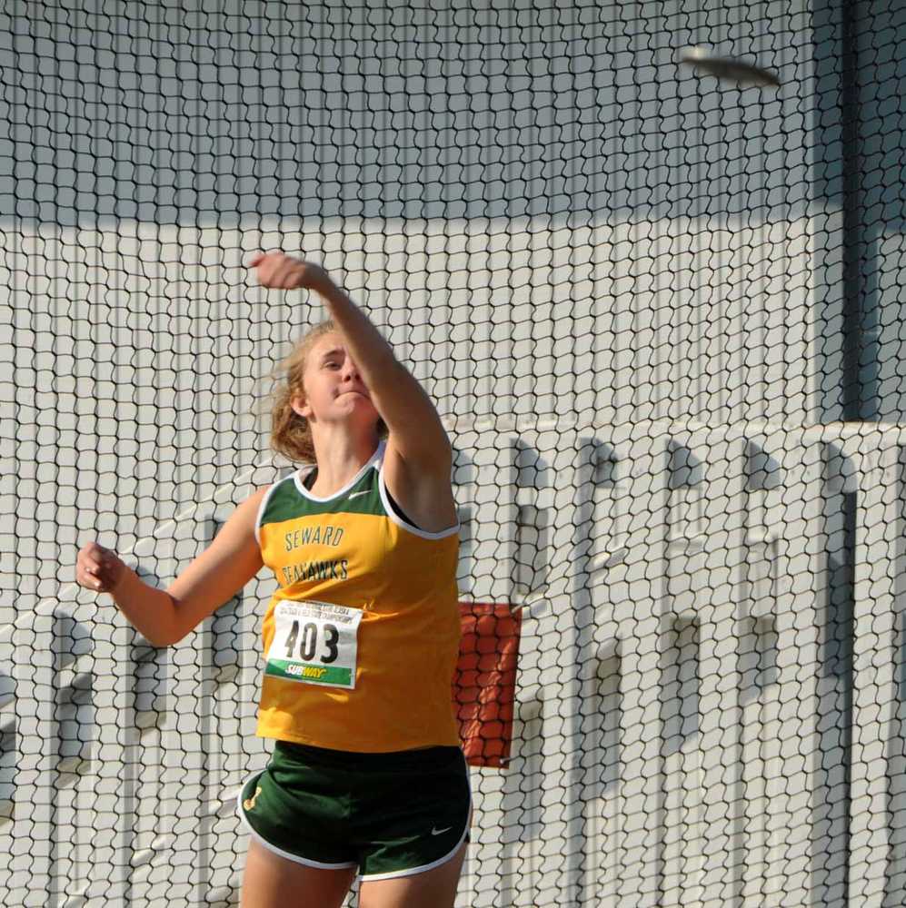 Laura Kromrey of Seward spins to a win in the 1A2A3A girls' discus at the state track and field championships on Friday, May 23, 2014, at Dimond High School in Anchorage, Alaska. Her mark of 99 feet, 9 inches claimed the event by more than 5 feet. (AP Photo/Anchorage Daily News, Erik Hill)