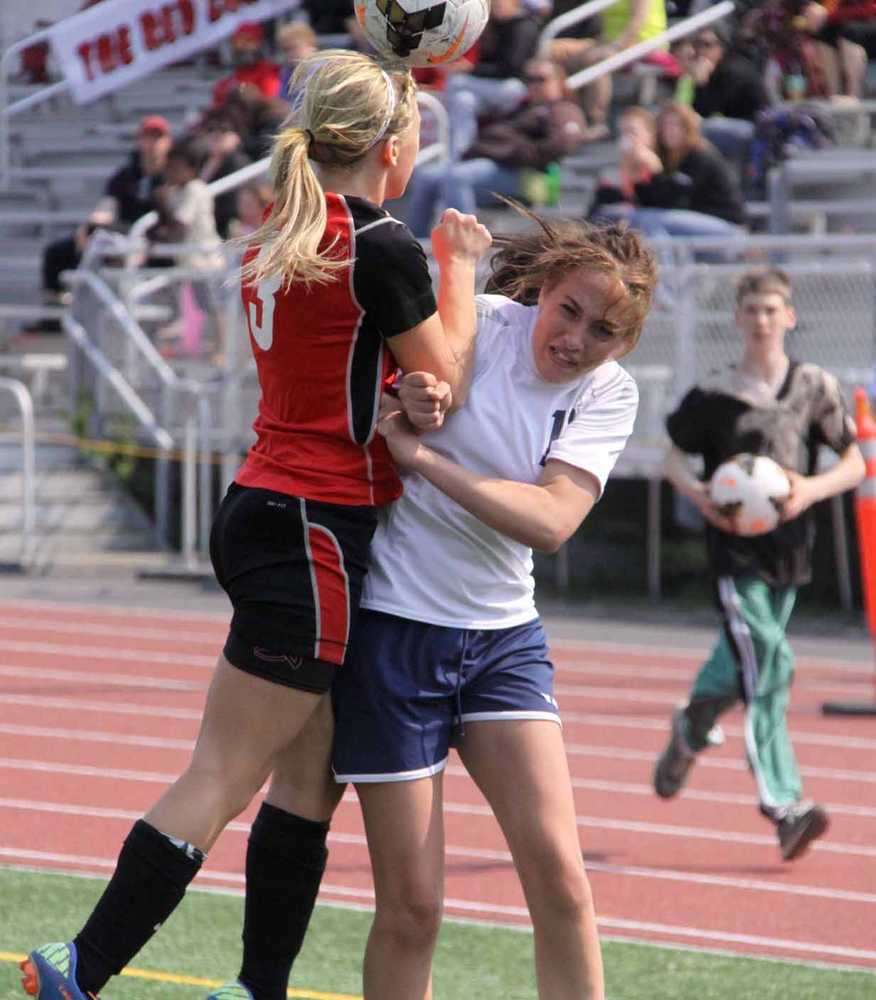 Kenai sophomore Kylie Morse heads the ball as she collides with Soldotna sophomore Alyssa Wolfe during the Northern Lights Conference girls title game May 25 at Wasilla High School. Soldotna won the match 5-0.