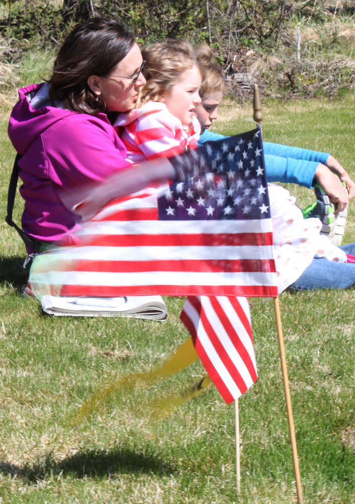 Photo by Kelly Sullivan/Peninsula Clarion Mandy Pieh, daughter Rebekah Pieh and son Josh Pieh sat close together in the brisks winds blowing during the Memorial Day service, Monday, May 26, at Soldotna Community Memorial Park.