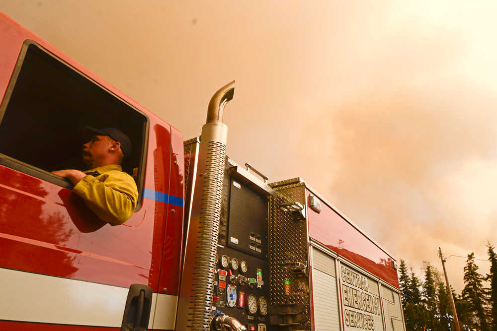 Photo by Rashah McChesney/Peninsula Clarion Central Emergency Services firefighter Dan Jensen acts as a firewatch under the haze of smoke from the Funny River Horse Trail wildfire Monday May 26, 2014 in Soldotna, Alaska.