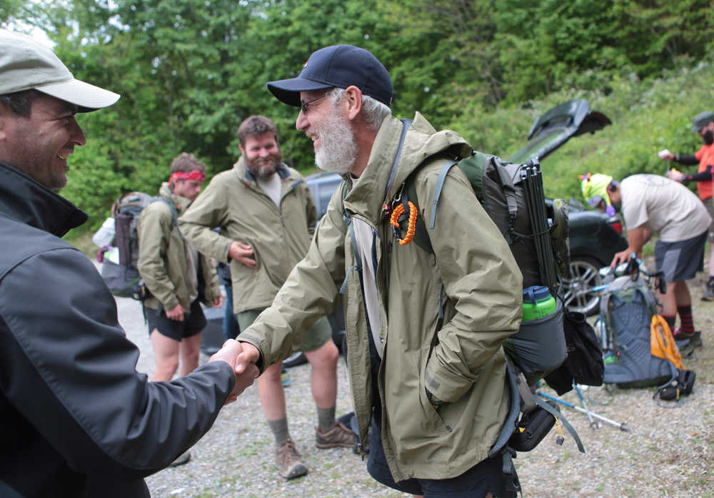 Sean Gobin, founder of Warrior Hike, shakes hands with Jamey Pierson at the Catawba Mountain trail head on May 17, 2014  in Catawba, Va.  Gobin founded the Warrior Hike to coordinate hikes for other veterans who are struggling to adapt to civilian life. This spring, 26 veterans set off on hikes along the AT, the Continental Divide Trail and the Pacific Crest Trail.  (AP Photo/The Roanoke Times, Erica Yoon)  LOCAL TV OUT; SALEM TIMES REGISTER OUT; FINCASTLE HERALD OUT;  CHRISTIANBURG NEWS MESSENGER OUT; RADFORD NEWS JOURNAL OUT; ROANOKE STAR SENTINEL OUT