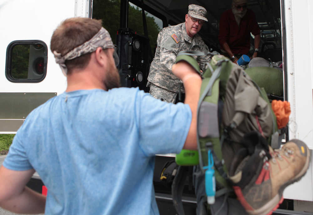 Sgt. 1st  Class Jody Martin helps load packs into a Department of Veterans Affairs vehicle from the Warrior Hikers on May 17, 2014  in Catawba, Va.  Sean Gobin founded the Warrior Hike to coordinate hikes for other veterans who are struggling to adapt to civilian life. This spring, 26 veterans set off on hikes along the AT, the Continental Divide Trail and the Pacific Crest Trail.  (AP Photo/The Roanoke Times, Erica Yoon)  LOCAL TV OUT; SALEM TIMES REGISTER OUT; FINCASTLE HERALD OUT;  CHRISTIANBURG NEWS MESSENGER OUT; RADFORD NEWS JOURNAL OUT; ROANOKE STAR SENTINEL OUT