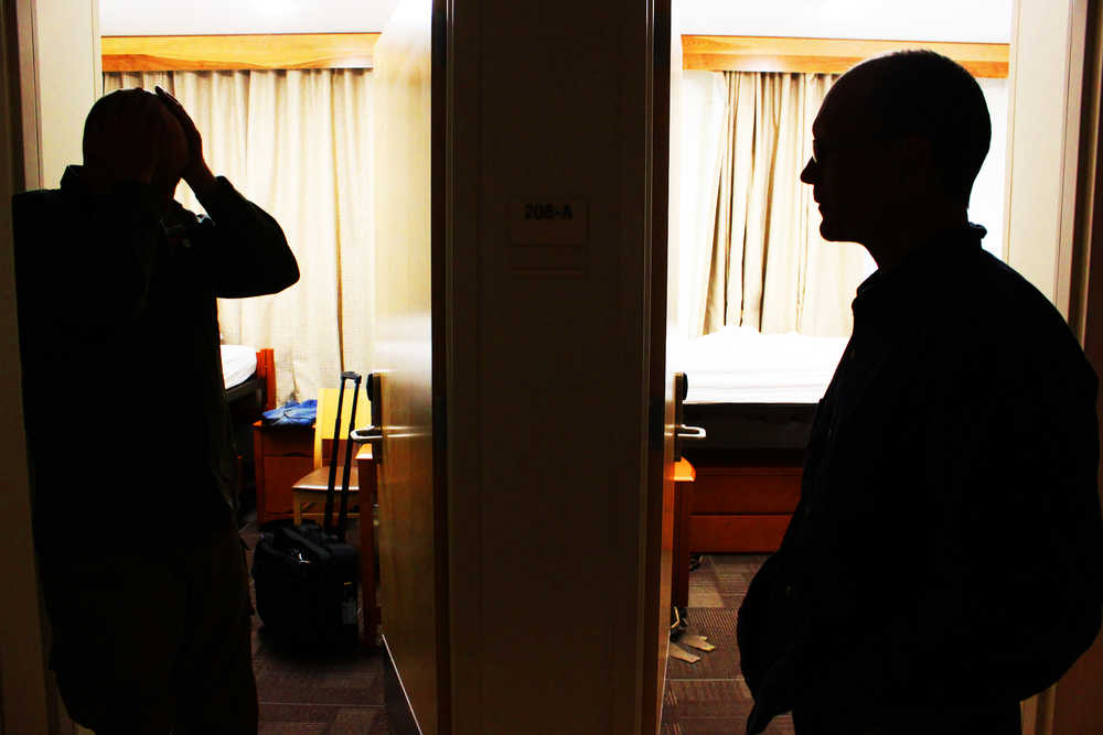 Photo by Kelly Sullivan/ Peninsula Clarion Marty Rogers and Michael Hatfield debrief after getting off their 24-hour-plus shift setting up the unmanned drones that will use unfrared radiation imaging to detect hotspots in the Funny River Fire, Thursday, May 29, at Kenai Peninsula College.