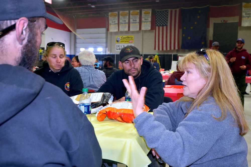 Photo by Dan Balmer/Peninsula Clarion Soldotna resident Lisa Lybrand thanks Fhurer Orejuela and other members of the Wolf Creek Hotshots at the appreciation dinner at the Soldotna Regional Sports Complex Sunday. More than 1,500 hamburgers and another 1,500 hot dogs were served up to firefighters and community residents.