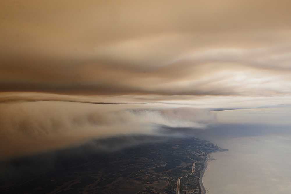 Photo by Rashah McChesney/Peninsula Clarion  A cloud of smoke obscures the sky on the east side of the Kenai Peninsula as a fire that started near Funny River Road consumed more than 7,000 acres of Kenai National Wildlife Refuge land Tuesday May 20, 2014. The fire stretches nearly 10 miles long and is moving east and west along the bank of Tustumena Lake.