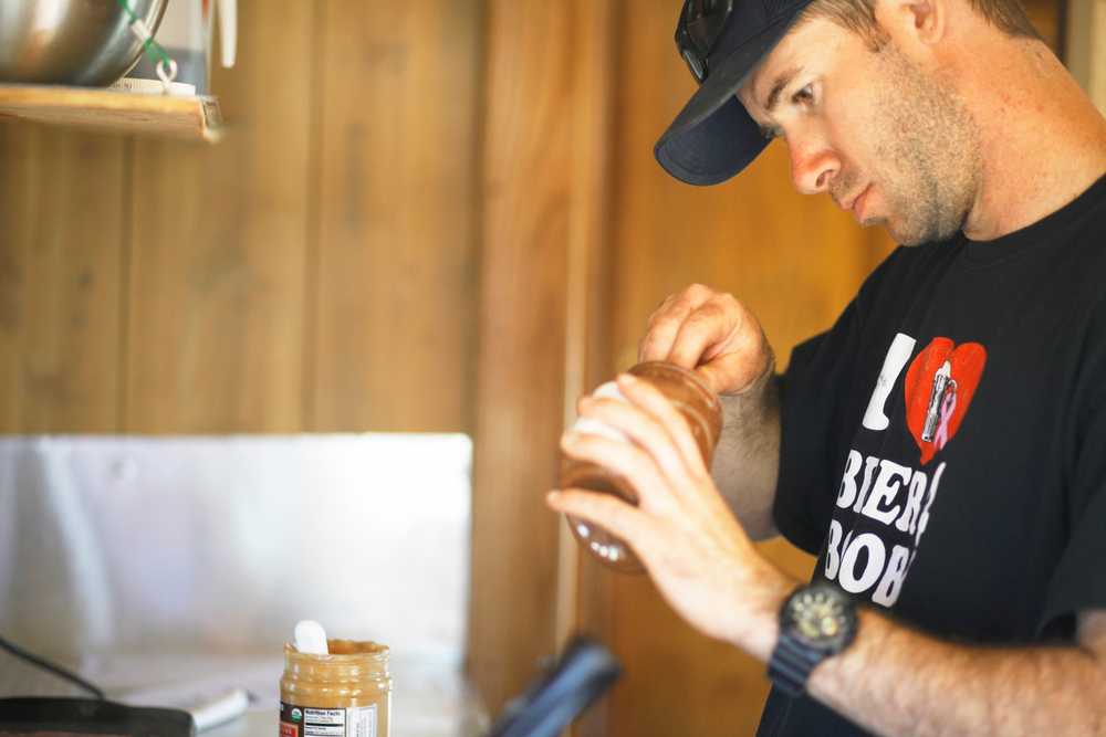 Photo by Kelly Sullivan/Peninsula Clarion Nick Calvert makes a bacon, peanut butter, nutella stuffed waffle in the bright, neon green RV converted into the Wook Waffaz Waffle Emporium, Thursday, June 5, in Soldotna.