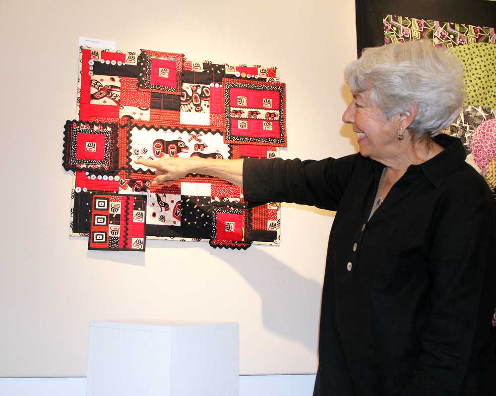 Photo by Dan Balmer/Peninsula Clarion Marilyn Kay Johnson points to her quilt "Bear Squared" on display at the Quilt Art Show at the Kenai Fine Arts Center Wednesday.