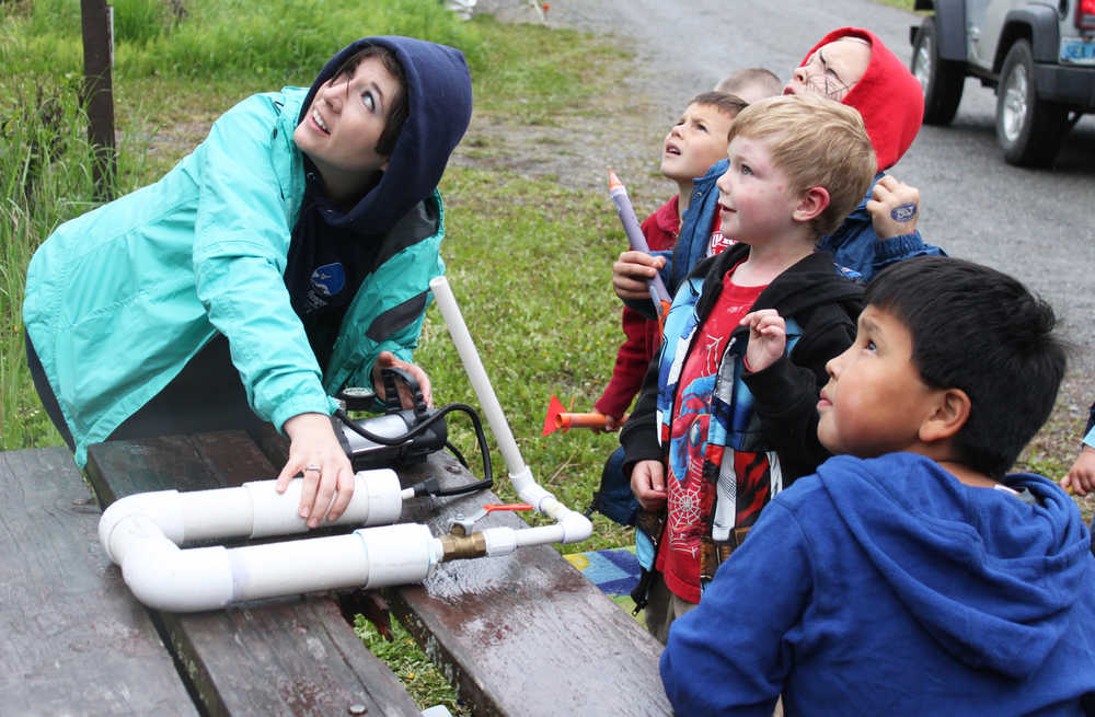 Photo by Kelly Sullivan/Peninsula Clarion Summer Lazenby and other children follow the launch of Caleb Wohlers River Rocket at the 24th annual Kenai River Festival, June 7, at Centennial Park.