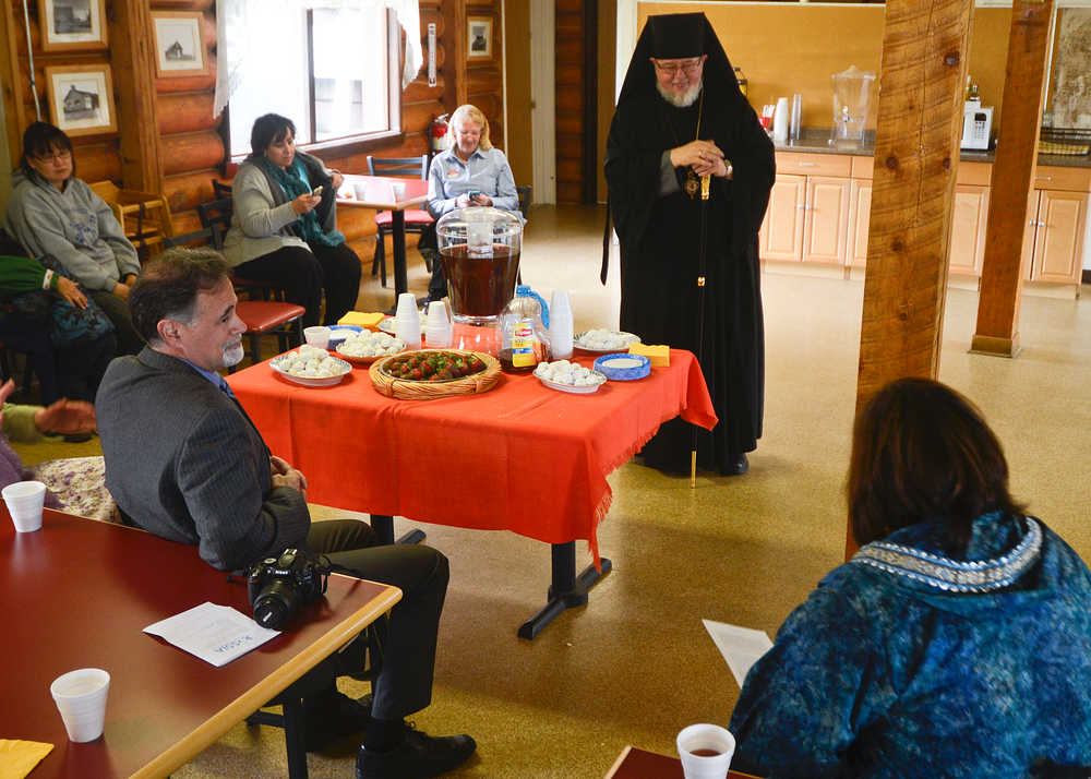 Photo by Rashah McChesney/Peninsula Clarion Sen. Peter Micciche, R-Soldotna, listens as Bishop David Mahaffey talks about the name of the Holy Assumption of the Virgin Mary's Russian Orthodox church's newly blessed outbuilding Thursday June 12 2014 in Kenai, Alaska.