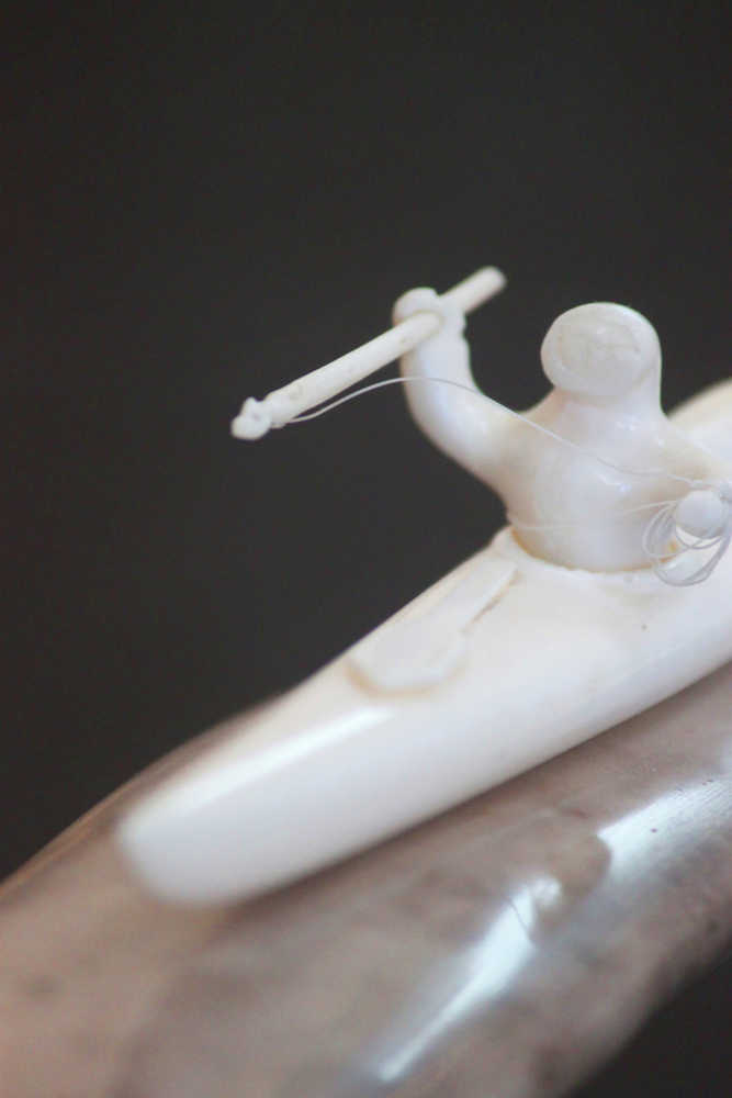 Photo by Kelly Sullivan/Peninsula Clarion This walrus ivory harpoon wielding carving is part of James Kunkles 90-piece art collection housed at the Soldonta Visitor's Center.