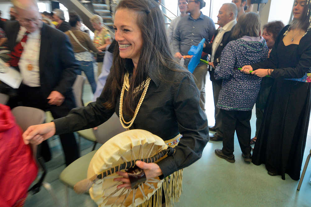Photo by Rashah McChesney/Peninsula Clarion  Bunny Swan-Gease helps to complete a large circle of people during a cloth-tearing ceremony to commemorate the grand opening of the Kenaitze Indian Tribe's Dena'ina Wellness Center Thursday June 12, 2014 in Kenai, Alaska.