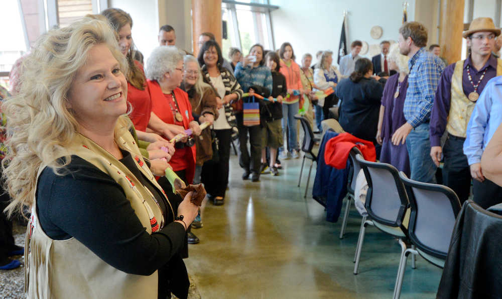 Photo by Rashah McChesney/Peninsula Clarion A cloth-tearing ceremony took place Thursday June 12, 2014 during the grand opening ceremony for the Kenaitze Indian Tribe's Dena'ina Wellness Center in Kenai, Alaska. Everyone who took part tore the cloth into pieces and carried a tangible reminder of the center with them for the rest of the evening.