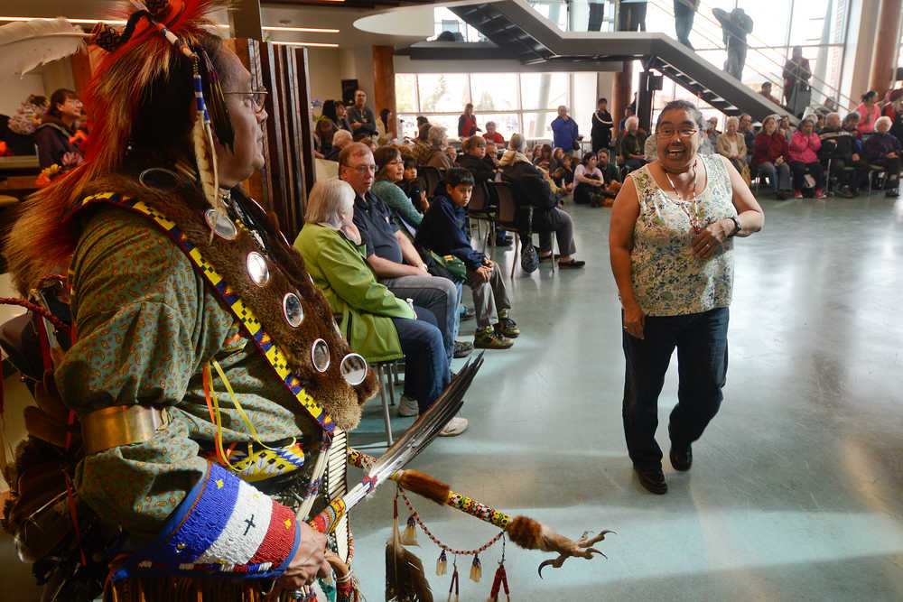 Photo by Rashah McChesney/Peninsula Clarion Yaqui and Otomi Indian Michael Rico smiles at native Yup'ik Rose Gilbeau of Kenai, who stopped when she saw his costume Friday June 13, 2014 during the second day of the grand opening ceremony for the Kenaitze Indian Tribe's Dena'ina Wellness Center in Old Town Kenai, Alaska.