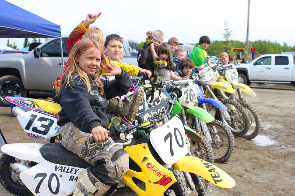 Photo by Kelly Sullivan/ Peninsula Clarion Trinity Pendergrass sits with her riding group Team Valley Rally from Mat-Su, Saturday, at Twin City Raceway.