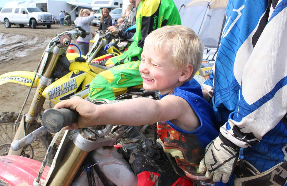 Photo by Kelly Sullivan/ Peninsula Clarion Chase Anderson sits on the bike in front of his brother, both part of the large group or riders Team Valley Rally from Mat-Su, Saturday, at Twin City Raceway.