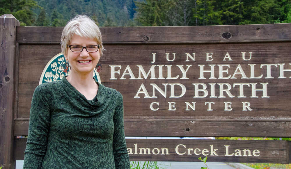 In this June 3, 2014 photo, Kay Kanne stands for a photo outside of the Juneau Family Health and Birth Center in Juneau, Alaska. Kanne can be considered the mother of midwifery in Alaska. After practicing midwifery for three decades, attending more than 1,000 births and opening the JFHBC in Juneau, Kanne retired from the birth center in April. (AP Photo/The Juneau Empire, Marlena Sloss)