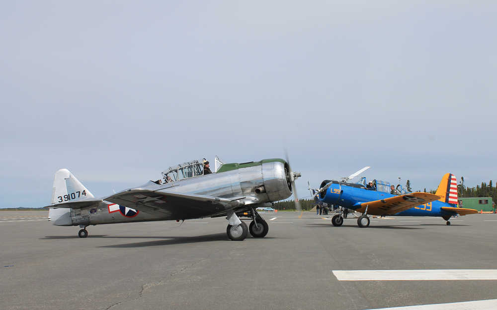 Photo by Will Morrow/Peninsula Clarion A pair of aircrafts from the Alaska Wing of the Commemorative Air Force taxi on the tarmac at the Kenai Municipal Airport during the Kenai Peninsula Air Fair Saturday afternoon. The planes were among a number of vintage aircraft taking part in the event.