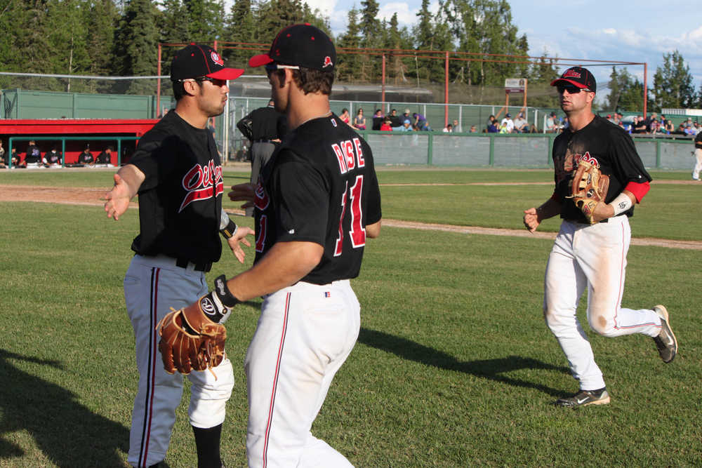 Photo by Kelly Sullivan/Peninsula Clarion Carter Yagi greets and congradulates his teammates after an inning at Friday's game.