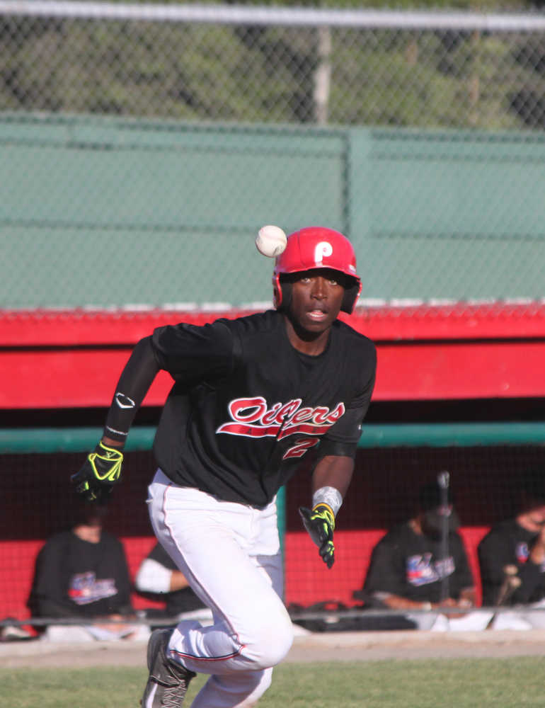 Photo by Kelly Sullivan/ Peninsula Clarion Mylz Jones notices the ball he just hit as he runs toward first base at Friday's game.