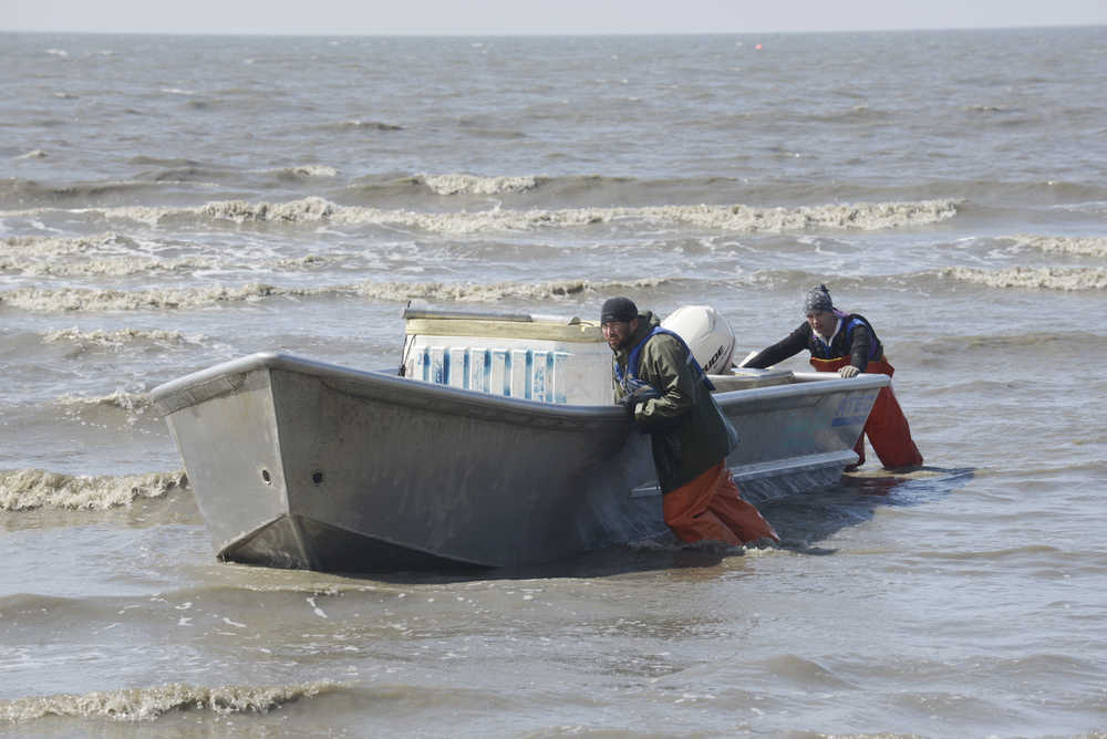 Photo by Rashah McChesney/Peninsula Clarion   Setnetters in the Kasilof Section of the East Side Setnet Fishery push a boat into shore June 27, 2013.  A judge recently denied a motion of a preliminary injunction in a lawsuit over Cook Inlet commercial salmon management that would have required the Alaska Department of Fish and Game to change it's management.