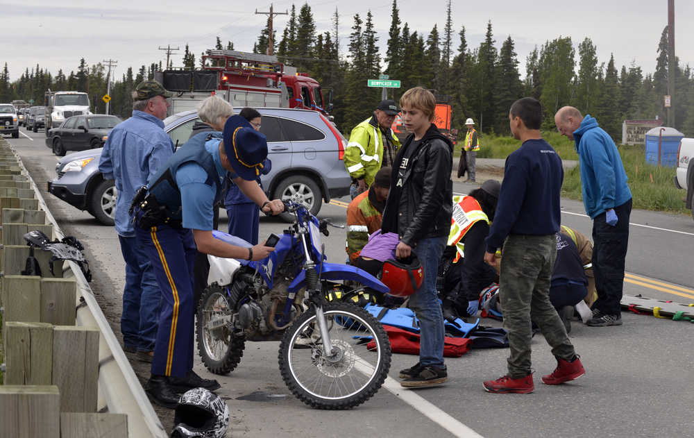 Photo by Dan Balmer/Peninsula Clarion A 16-year-old girl on a motorbike was struck by a white Chevy truck when she attemped to cross Kalifornsky Beach Road between VIP Drive and Bowpicker Lane Wednesday at about 2:30 p.m. in Kenai. Alaska State Troopers said the girl sustained non-life threatening injuries and was transported to Central Peninsula Hospital. The minor was wearing a helmet, but troopers said she did not look before she crossed the street.