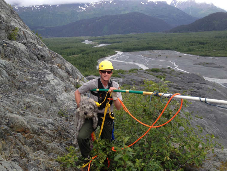 Kenai Fjords National Park Ranger John Anderson is shown with Sadie after her rescue from a ledge near a glacier on Monday, June 30, 2014, at Kenai Fjords National Park, Alaska. (AP Photo/National Park Service, Mark Thompson)