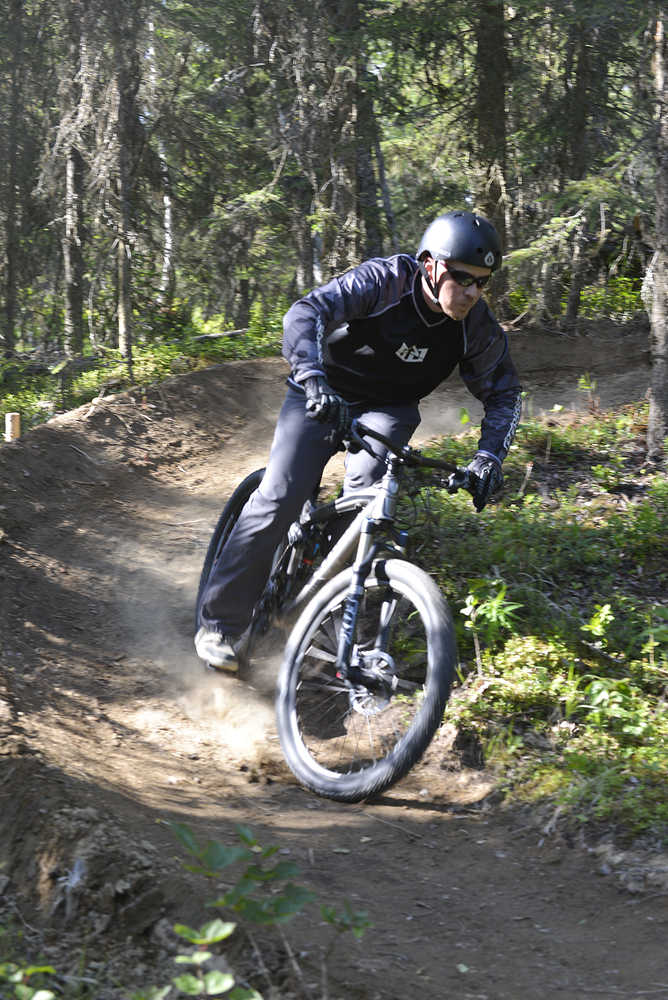 Photo by Rashah McChesney/Peninsula Clarion  Shawn Schooley, one of the designers of the new singletrack mountain bike trail at the Tsalteshi Trails Wednesday July 2, 2014 on the Mosquito Trail in Soldotna, Alaska.