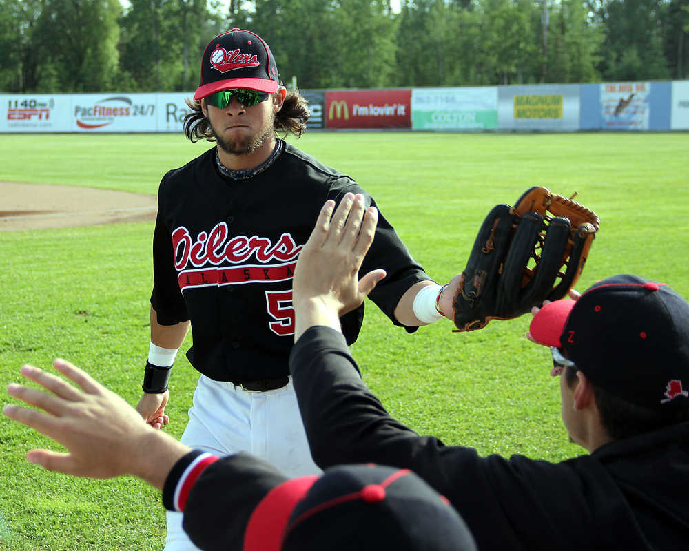 Photo by Dan Balmer/Peninsula Clarion Peninsula Oilers centerfielder Jake Sandlin returns to the dugout at the end of the first inning in Thursday's home game against the Chugiak-Eagle River Chinooks at Coral Seymour Memorial Park.