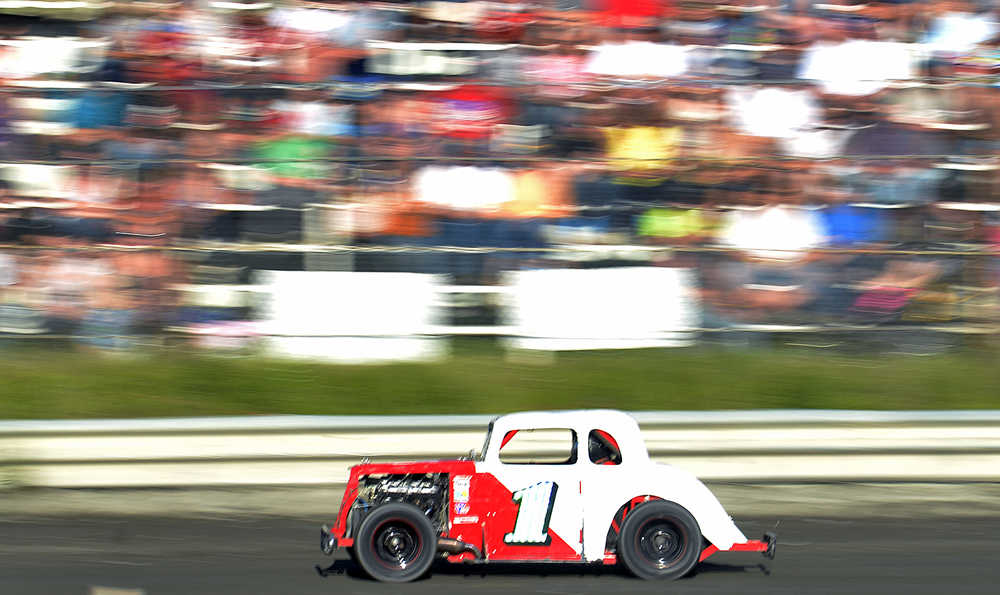 Photo by Rashah McChesney/Peninsula Clarion .... races past the crowd during a Legend car race Friday July 4, 2014 at the Twin Cities Raceway in Kenai, Alaska.