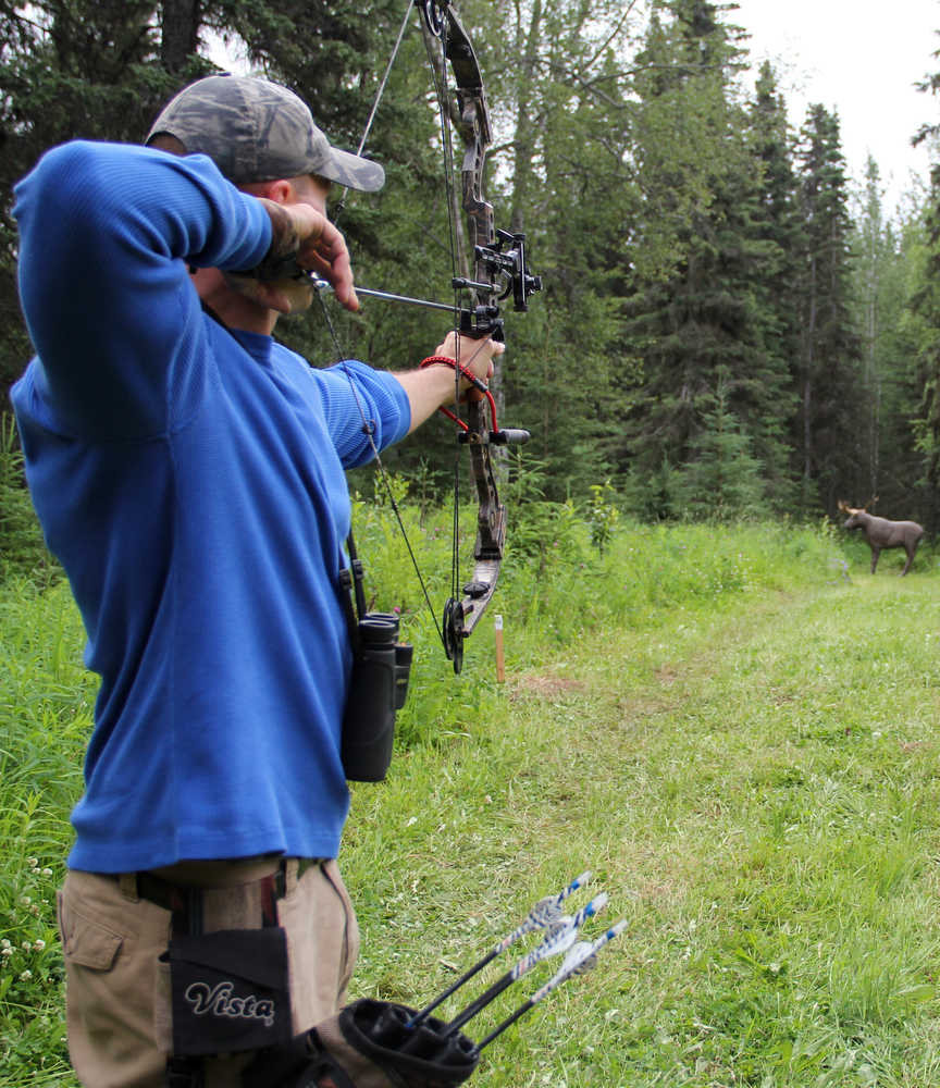 Photo by Dan Balmer/Peninsula Clarion Gerald Bickford from Anchorage lines up his shot and prepares to release his arrow at a 3-D Rinehart moose target at the Independence Day Marked 3-D Archery Shoot Tournament Sunday at the Kenai Peninsula Archery Range in Soldotna. The statewide tournament drew 76 archers for the two-day competition.