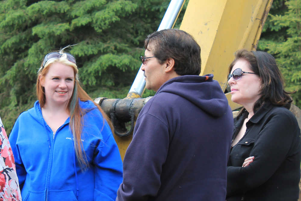 Photo by Will Morrow/Peninsula Clarion New Habitat for Humanity homeowner Crystal Stonecipher, left, chats with Ramon and Eduviges Carreon at a groundbreaking event in Kenai on June 14. The Carreons recently paid off the mortgage on their Habitat home, which they moved into in 1995.