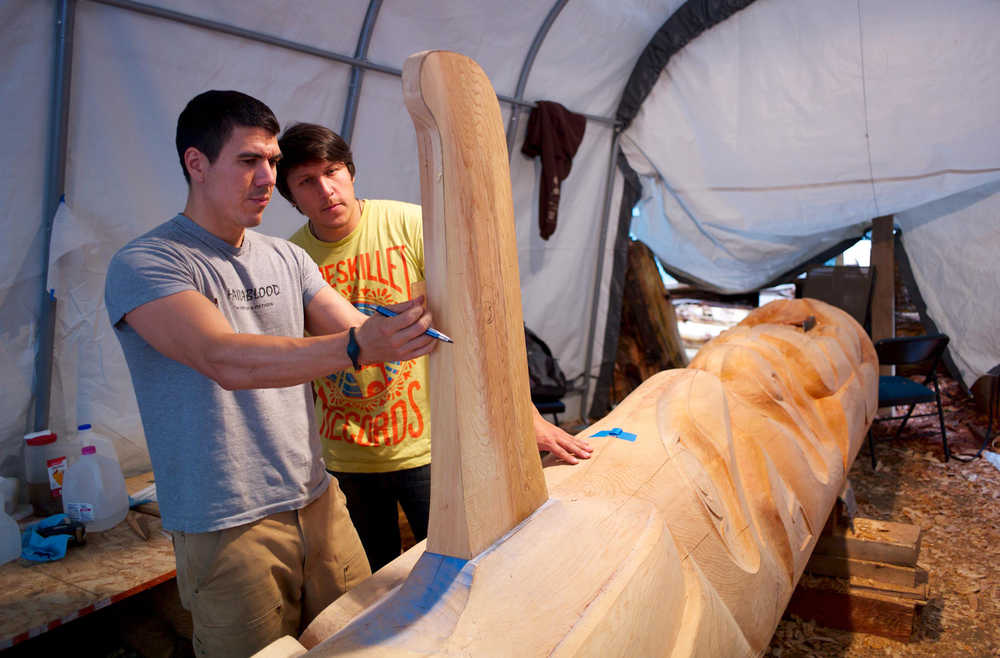 Haida carver TJ Young works with apprentice Jerrod Galanin on the Eagle totem pole for the Gajaa Hít building on Thursday. TJ and his brother, Joe, have been working on two poles and a screen to replace the aging ones in front of the building. The project was organized through Sealaska Heritage Institute in conjunction with the Tlingit Haida Regional Housing Authority, who owns the building.
