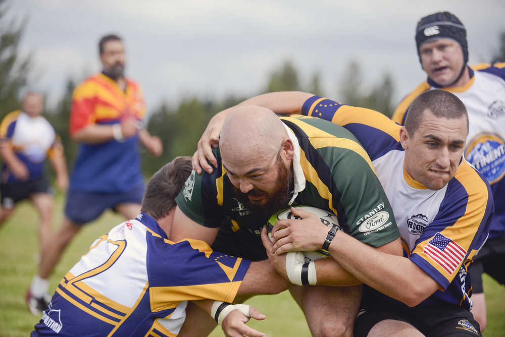 Photo by Rashah McChesney/Peninsula Clarion  Kenai River wolfpack Fred Koski is taken to the ground during a rugby game for the the Between the Tides Dipnet Tournament Saturday July 12, 2014 in Kenai, Alaska.