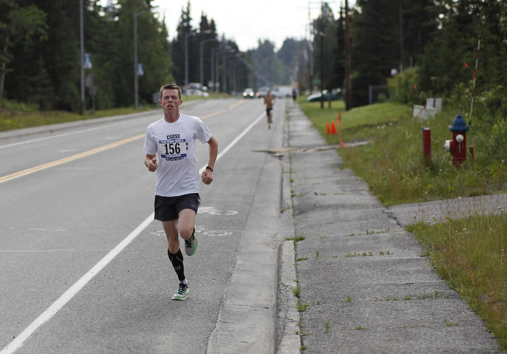 Photo by Rashah McChesney/Peninsula Clarion  Rex Shields finishes the Unity Run in first place with a time of about 15:35 Saturday July 12, 2014 in Soldotna, Alaska.