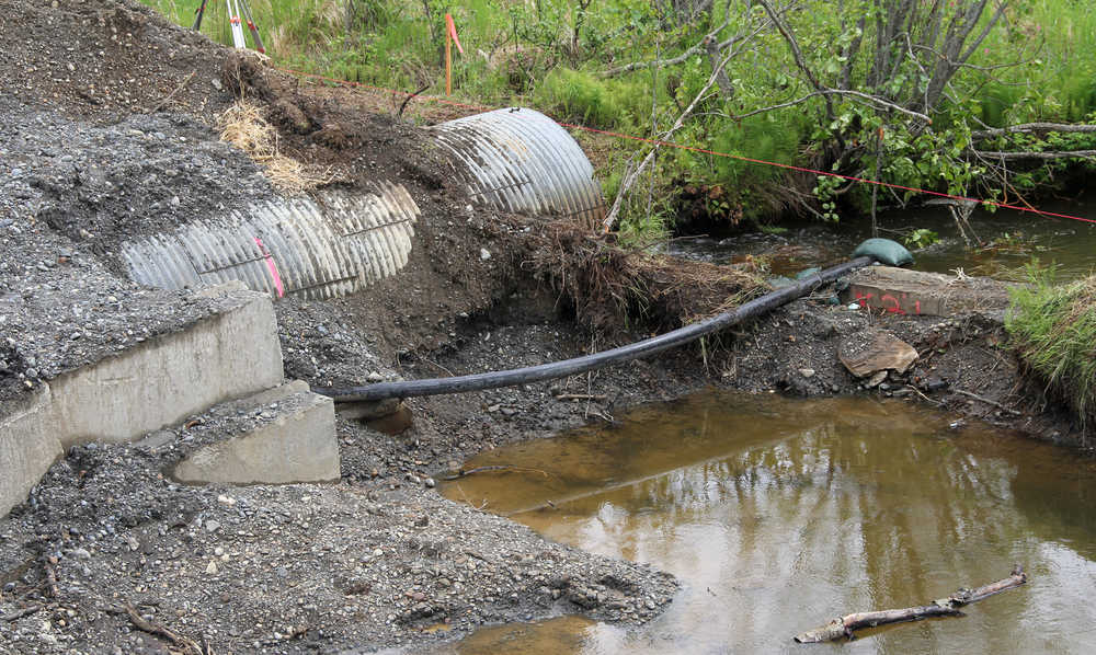 Photo by Dan Balmer/Peninsula Clarion The existing culvert under Beaver Loop Road sits half a foot above the stream, which has made it near impossible for juvenile fish to swim through and reach their spawning habitat. High groundwater seen her in a Clarion file photo in June, has been part of the reason for a six-week delay in the completion of a Kenai Watershed Forum project contracted by Endries Company.