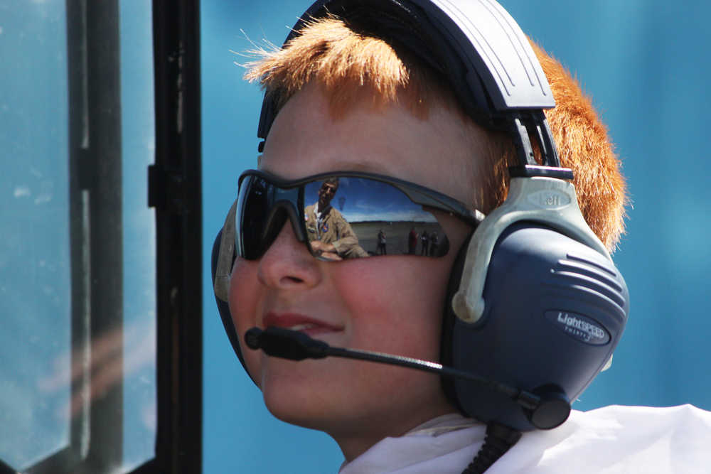 Photo by Kelly Sullivan/ Peninsula Clarion Lucas Cragg listens as pilot Alex Roesch coaches the Kenai Civil Air Patrol Cadet on handling the maintained World War II Advanced Trainer after takeoff, Saturday, at the Civil Air Patrol hanger.