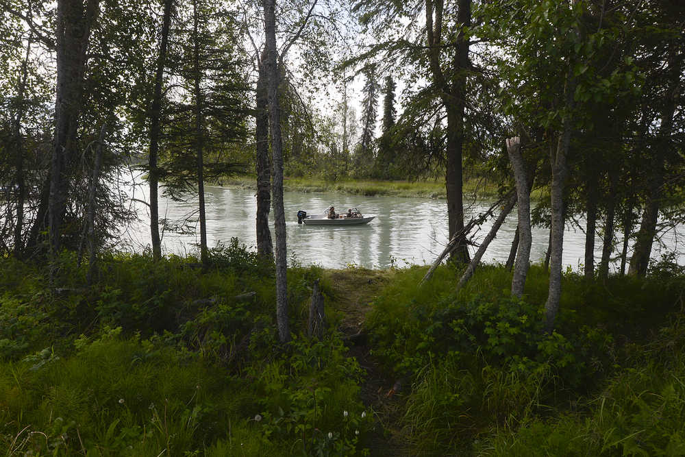 Photo by Rashah McChesney/Peninsula Clarion  Putting a boat into the Kenai River at the Eagle Rock boat launch can be an easier proposition than some - the area forms a natural slough, sheltering boats from the swift currents of the river. Here, a boat puts in and motors through the calm water Friday July 18, 2014 in Kenai, Alaska.
