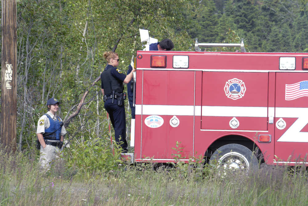 Photo by Rashah McChesney/Peninsula Clarion  Kenai firefighters and police responded to small fire on Bridge Access Road Tuesday July 22, 2014 in Kenai, Alaska.